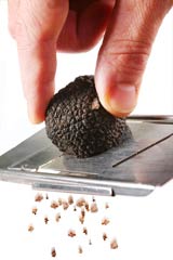 slicing black truffle with truffle slicer
